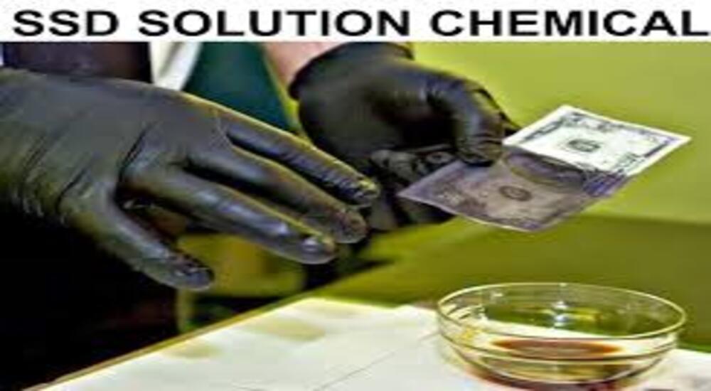 Person cleaning black money with SSD chemical